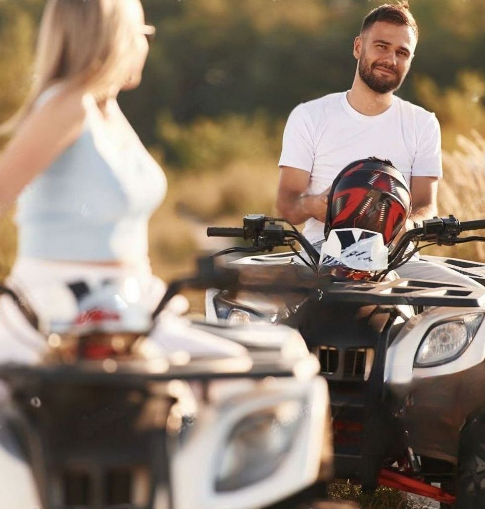 People riding ATVs at sunset